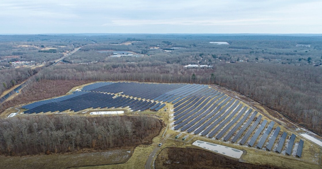 Arial image of hundreds of solar panels covering a vast landscape 