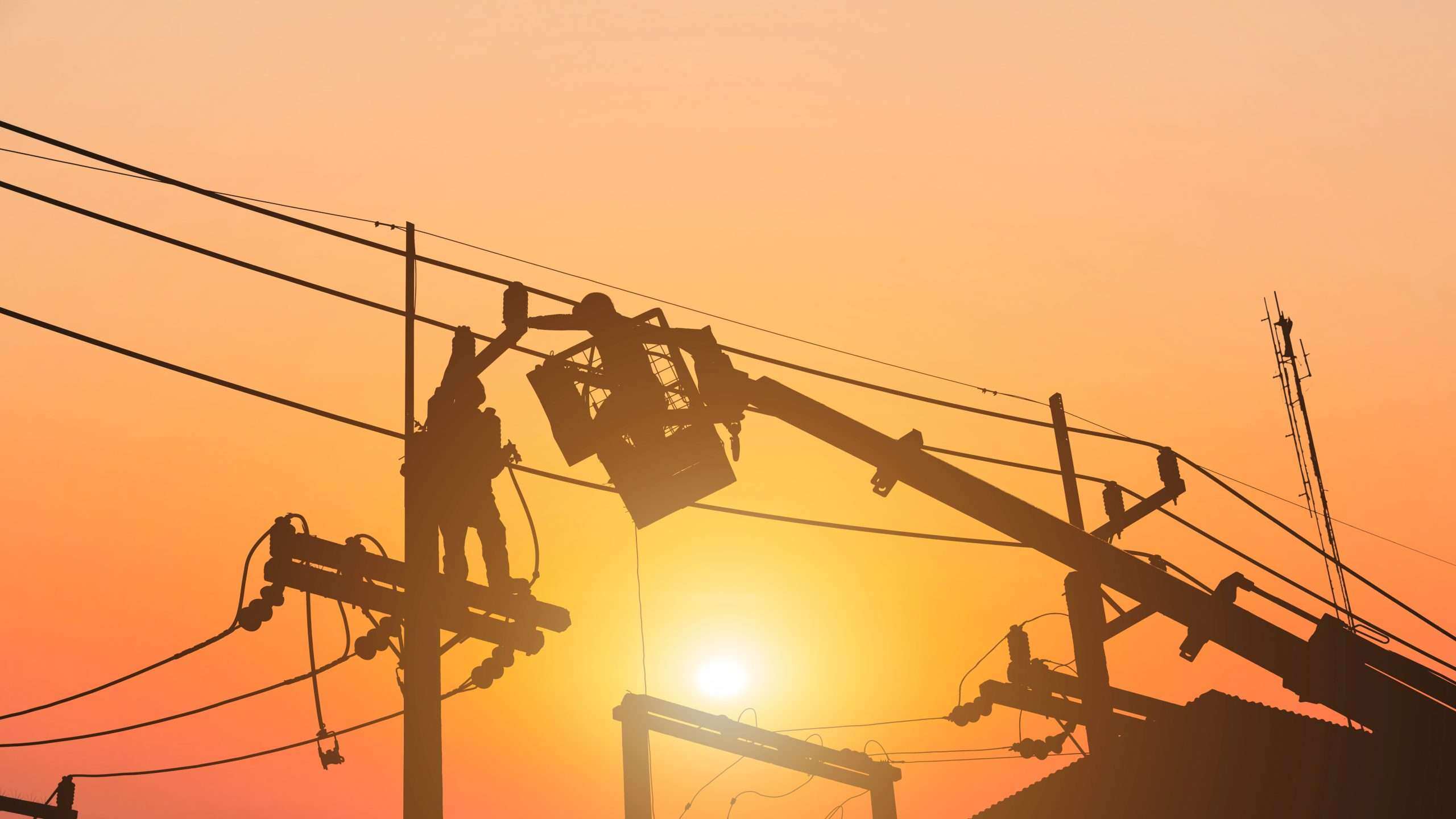 Utility worker fixing power lines