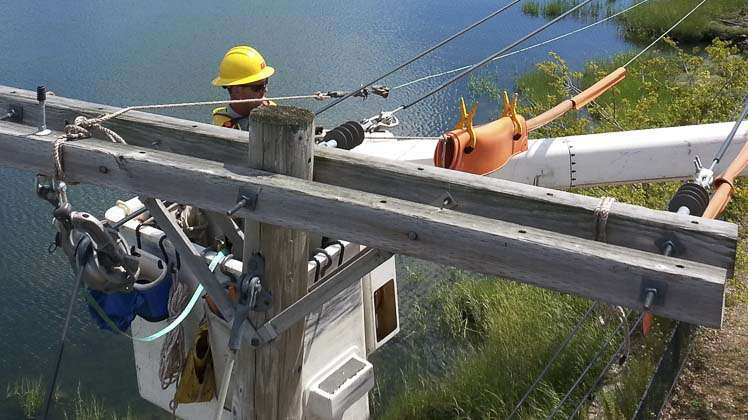 utility worker accessing power line